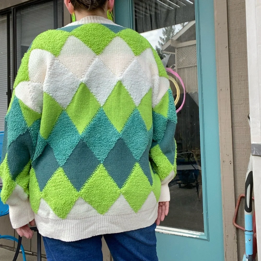 Green and cream harlequin patterned button up sweater